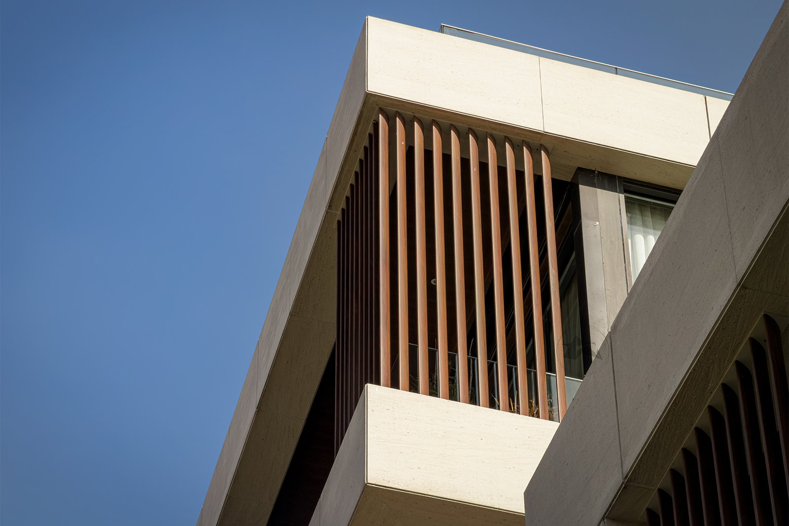 Modern aluminium architectural louvers on a residential building facade designed by Axes in Excess
