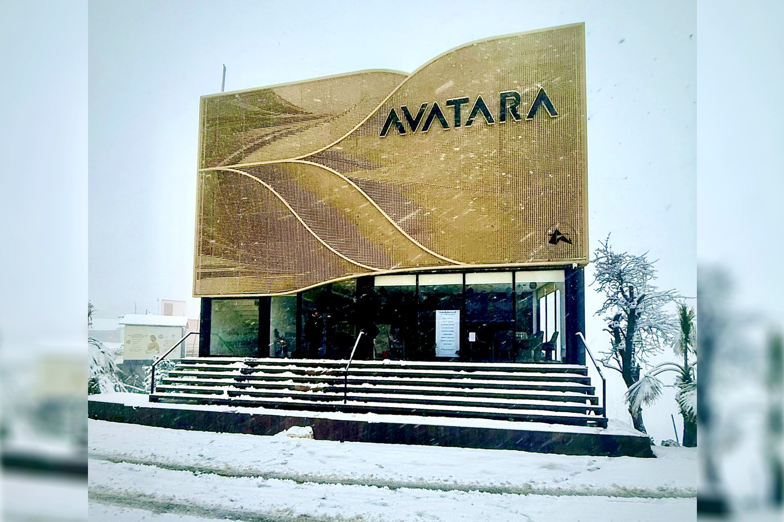 Axes in Excess sculptural gold facade with flowing curved geometry in high-altitude setting