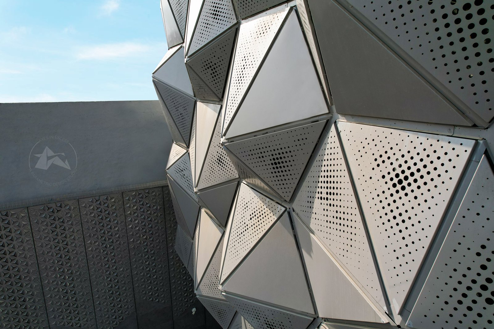 Modern hotel facade design in India with metal panels by axes in excess