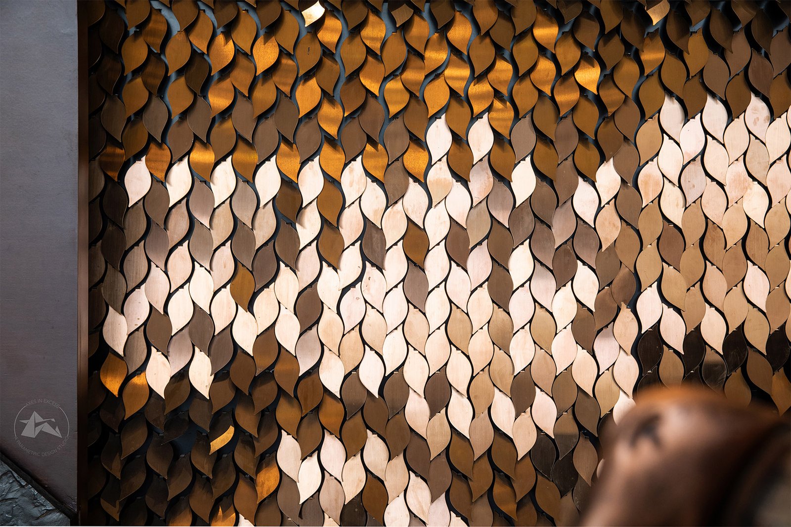 modern reception wall design with metal leaves by axes in excess