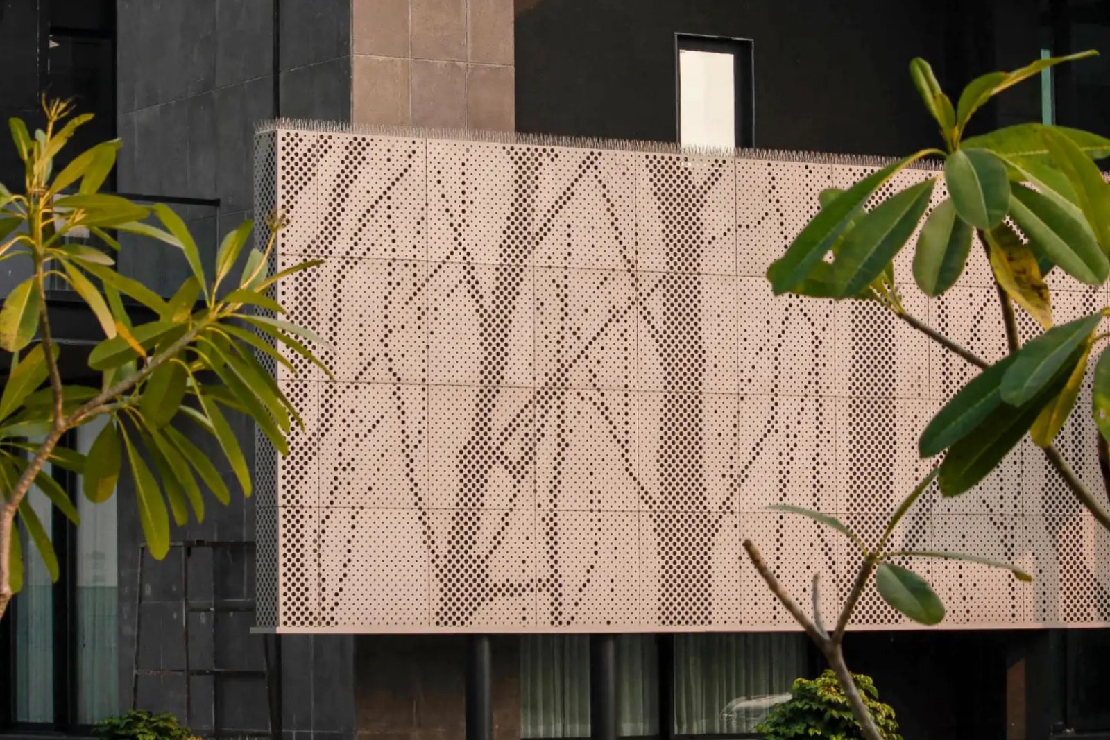 Wood-finish aluminium fluted panels adding linear texture to the exterior of Rewari Farm in Haryana.